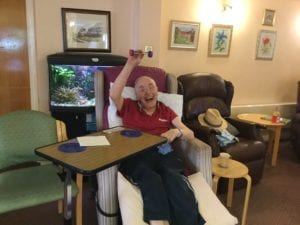 Archie, a Hospice patient, weightlifting in the Hospice Olympics