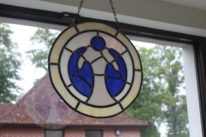 Mary Stevens Hospice logo created in leaded stained glass of blue and white