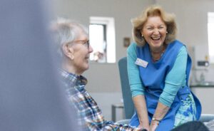 Hospice volunteer laughing with a patient